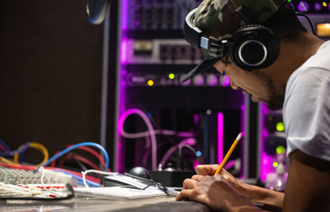 A young New Zealand rapper putting his idea into a song in a recording studio